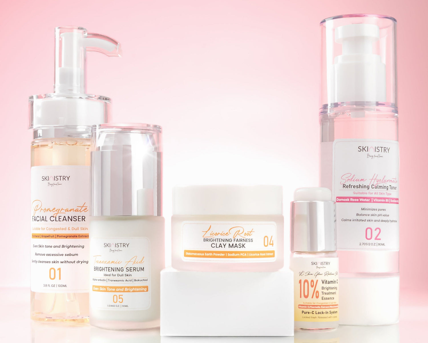 Set of skincare products with visible brand names Skinistry on a pink background